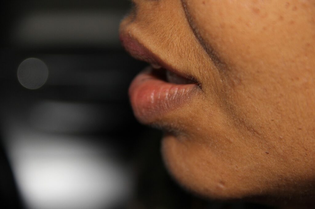 Close up side view of a woman's face from the lips to the chin